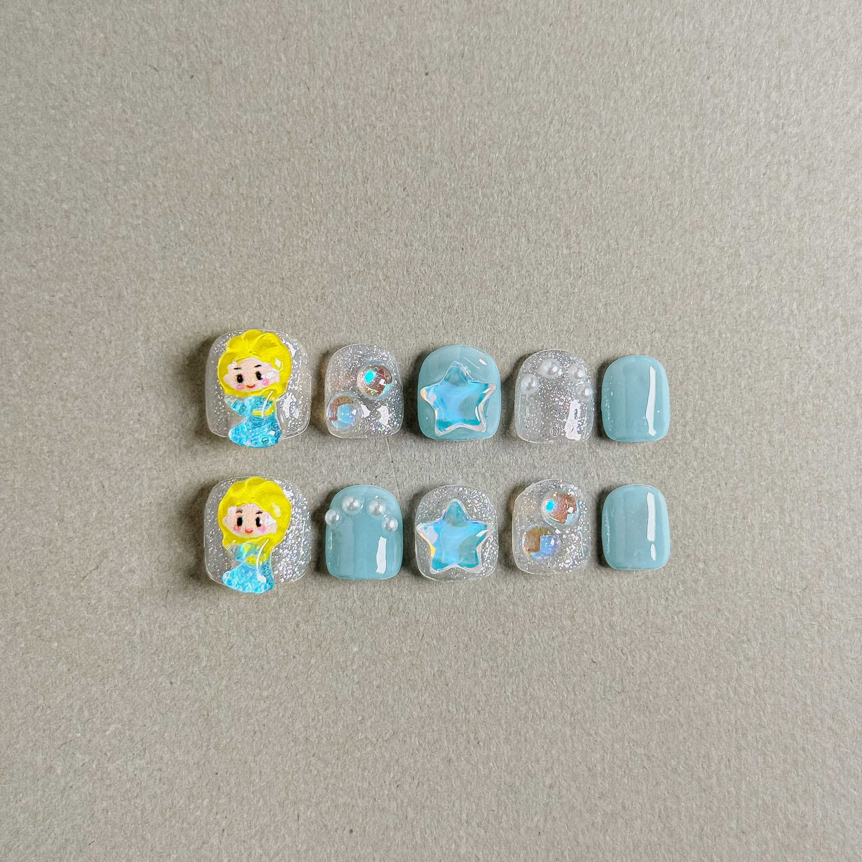 Gorgeous Glacier press on nails with cute character design and sparkling elements, featuring Nail art designs and Glitter nails, ideal for Holiday nails