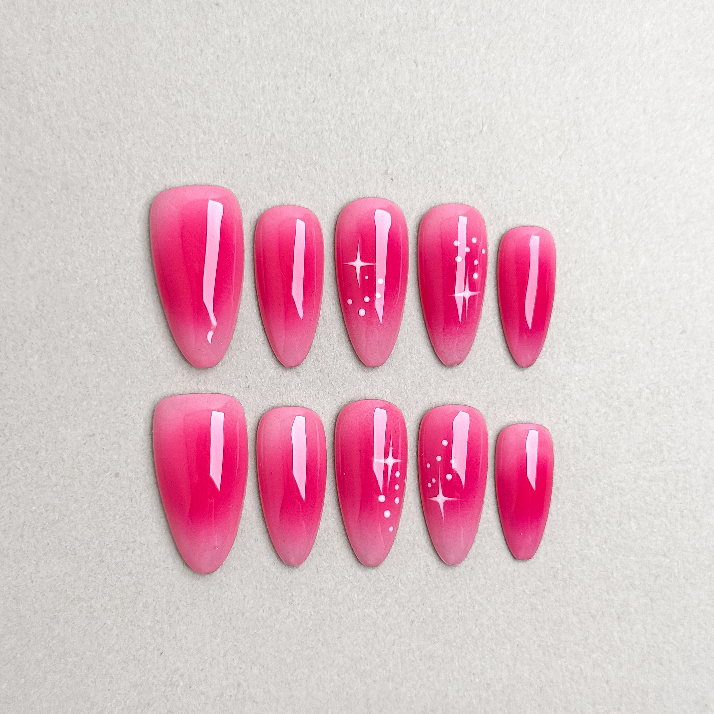 Set of reusable press-on nails in vibrant hot pink with glossy finish, MIBLAB Cherry Bomb collection Geneva.