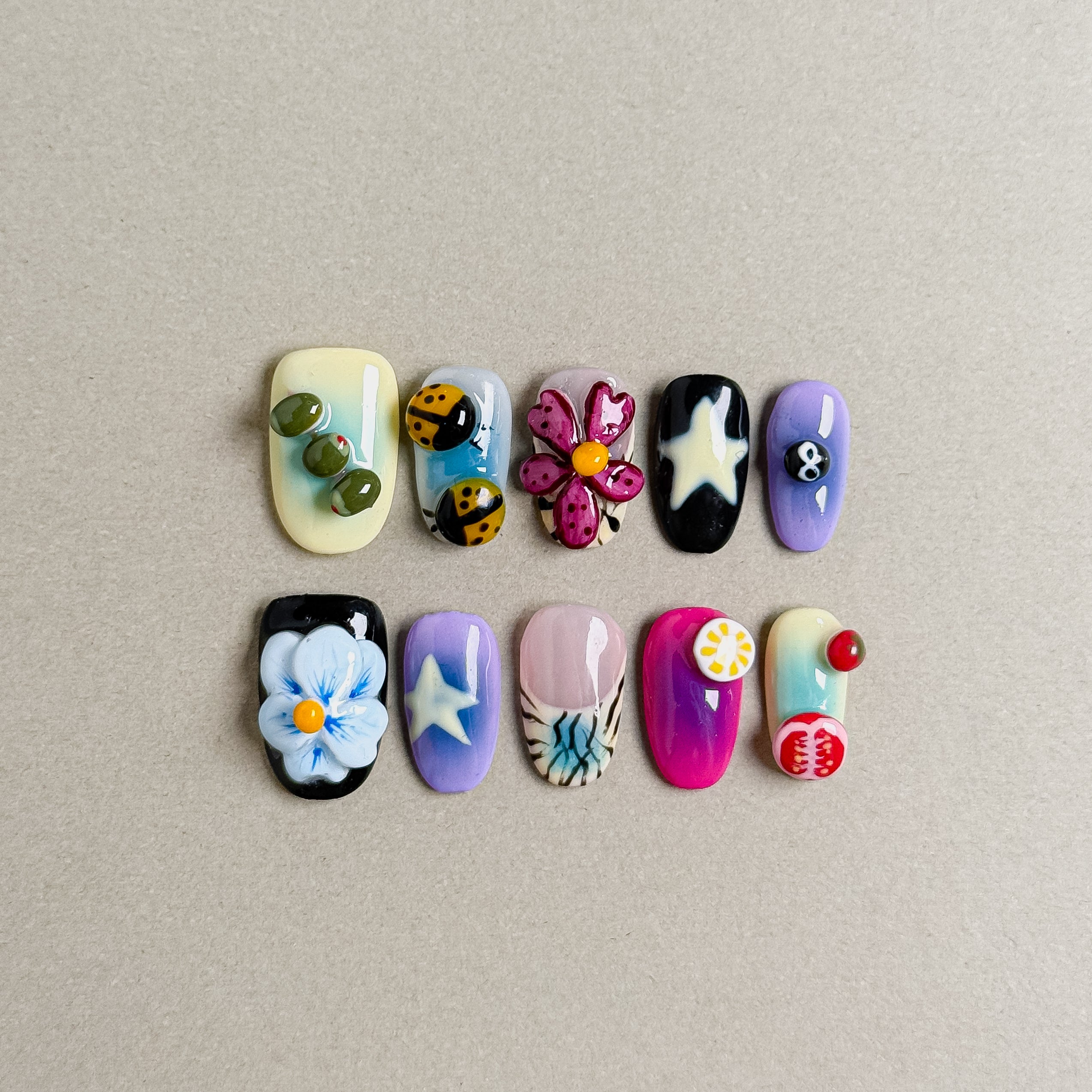 Colorful Sugar Plum press on nails showcasing various Nail art designs including flowers, stars, and unique elements, suitable for Party nails and Holiday nails