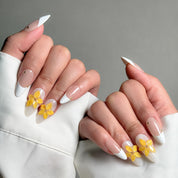 Elegant Almond nails featuring a classic French tip nails design with delicate yellow flower accents. These Custom press on nails are perfect for Wedding nails or special occasions, showcasing intricate Nail art designs. The combination of timeless French tips and vibrant floral details creates a sophisticated and feminine look. Ideal for those seeking Luxury press on nails that are both stylish and elegant.