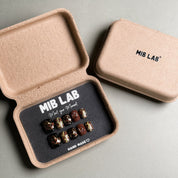 A set of Handmade press on nails with a bold leopard print and gold accents, presented in eco-friendly packaging. These Custom press on nails offer a stylish and edgy look, perfect for Party nails or everyday wear. The box, labeled "MIB LAB" and "Meet Your Moment", highlights the brand's dedication to creating memorable Nail art designs. Ideal for those seeking Reusable fake nails that make a statement.