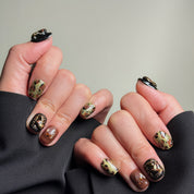 Short nails design featuring a bold leopard print and gold accents, creating a stylish and edgy look. These Custom press on nails are perfect for adding a touch of animal print to any outfit. The intricate details and rich colors make them ideal for Party nails or everyday wear. These Handmade press on nails demonstrate expert craftsmanship and are perfect for those seeking Luxury press on nails that stand out.