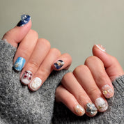 Detailed Nail art designs featuring a mix of 3D embellishments, glitter, and pearl accents on Short nails design. These Custom press on nails showcase a variety of styles, from celestial blue to elegant neutrals, perfect for Party nails or special occasions. The intricate details and textures highlight the craftsmanship of these Handmade press on nails. Ideal for those seeking Luxury press on nails with unique and eye-catching designs.