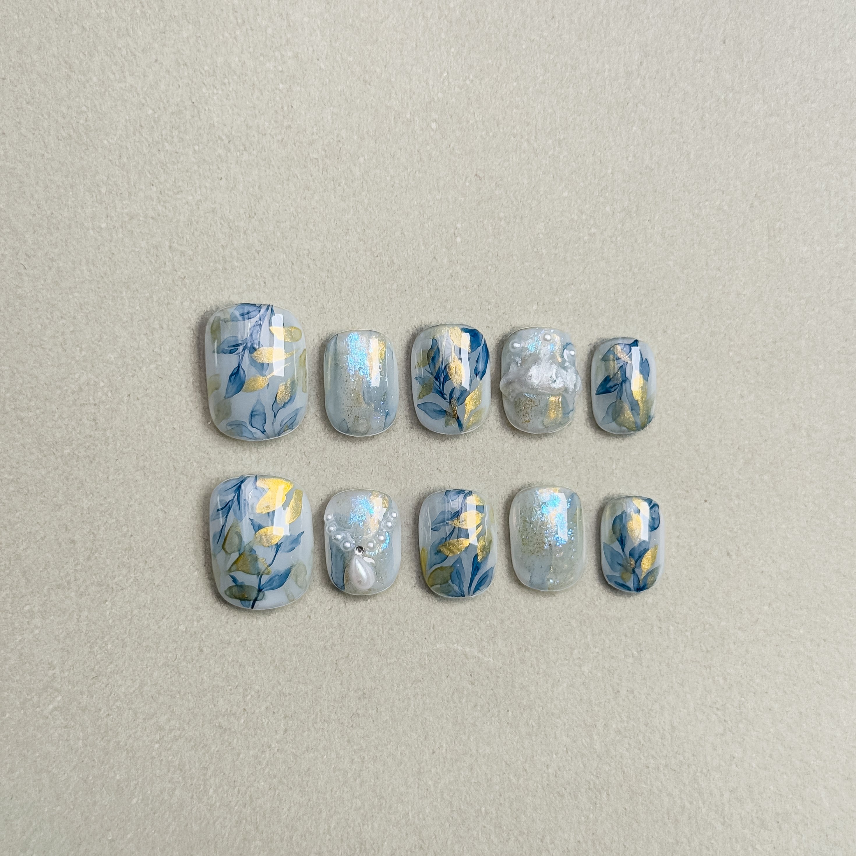 Elegant Jardin Bleu press on nails with delicate leafy designs and gold accents, featuring Nail art designs and Natural looking nails, perfect for Wedding nails