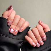 A collection of Handmade press on nails with pink and glitter accents, neatly arranged in eco-friendly packaging. These Luxury press on nails feature intricate designs, perfect for a special occasion or as Wedding nails. The box, labeled "MIB LAB" and "Meet Your Moment", highlights the brand's dedication to creating memorable Nail art designs. Ideal for those seeking Reusable fake nails that combine elegance with sustainability.