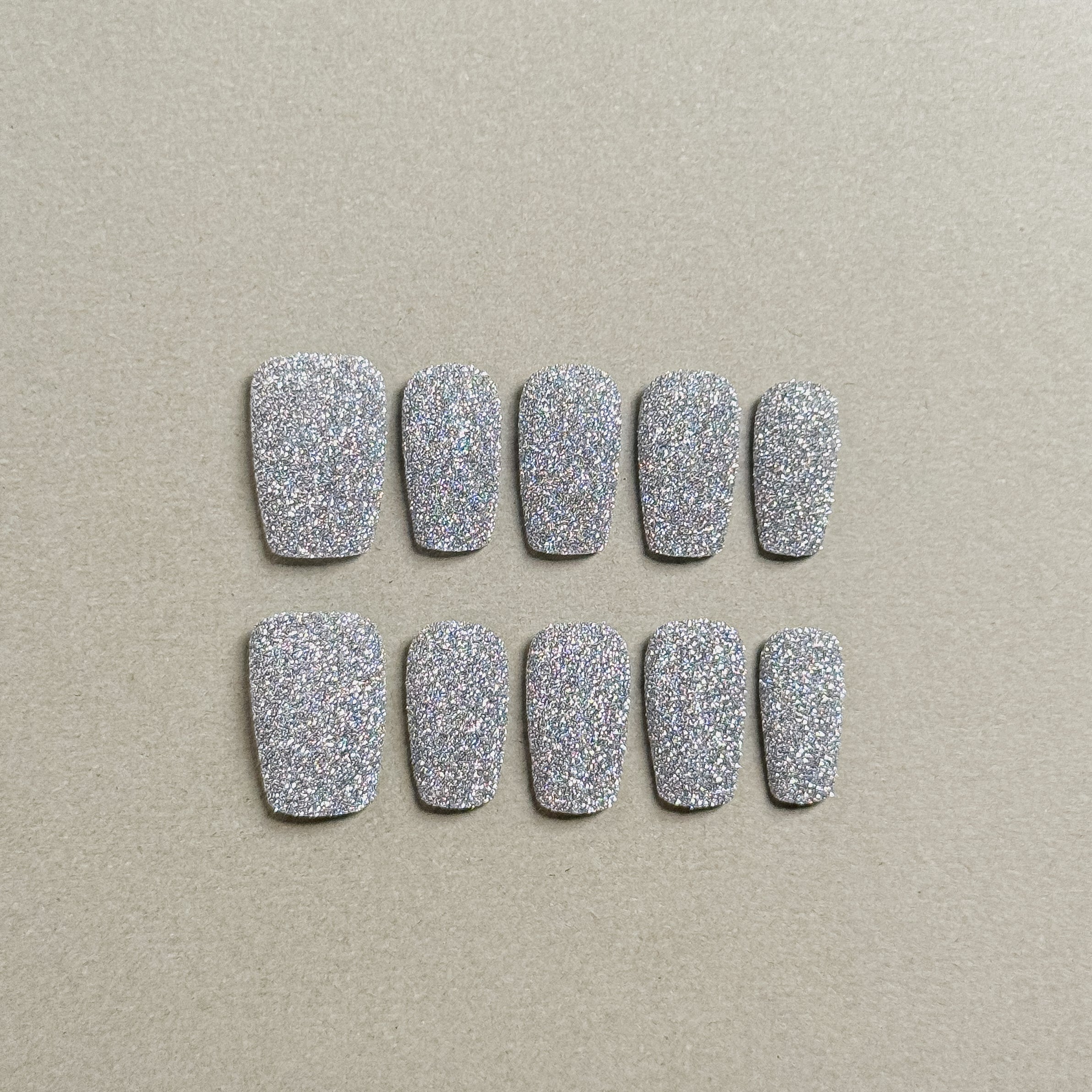A set of "Almost Home" short press - on nails covered in dense, sparkly glitter, providing a dazzling look that can be worn daily or for special occasions.
