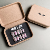 MIBLAB's mixed design press-on nails set, featuring marble, glitter, and solid colors. Packaged in an eco-friendly box with "MIB LAB" branding. Ideal for nail art designs and everyday nails, offering a luxury press on nails experience. Showcases a variety of handmade press on nails looks with trendy designs.