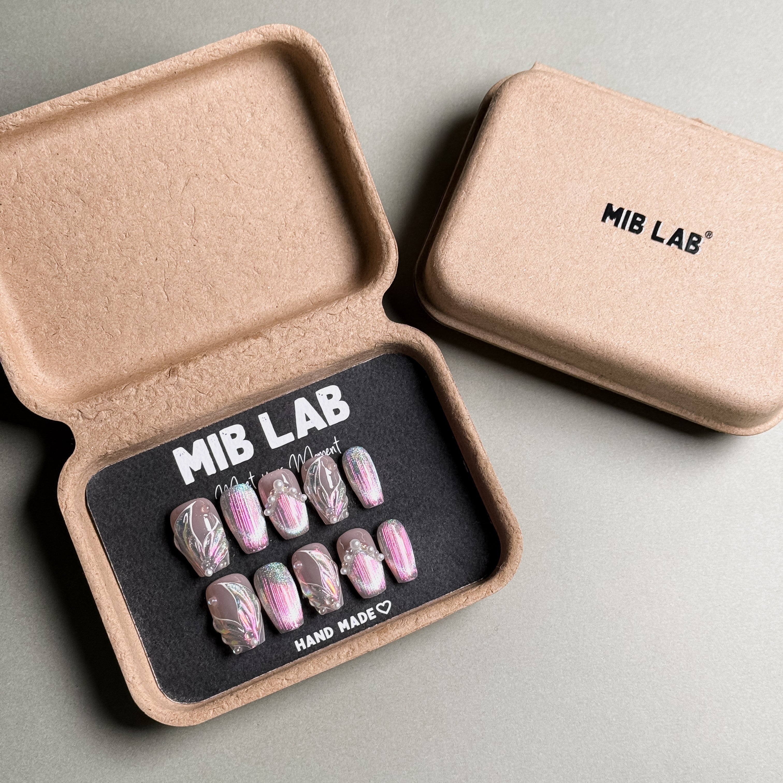 MIBLAB's mixed design press-on nails set, featuring marble, glitter, and solid colors. Packaged in an eco-friendly box with "MIB LAB" branding. Ideal for nail art designs and everyday nails, offering a luxury press on nails experience. Showcases a variety of handmade press on nails looks with trendy designs.