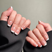 Hands showing MIBLAB's French tip nails with a classic white tip design. Features a clean, polished look ideal for everyday nails or wedding nails. Offers a luxury press on nails experience with professional nail art feel. These fake nails provide a natural looking nails effect with easy application.