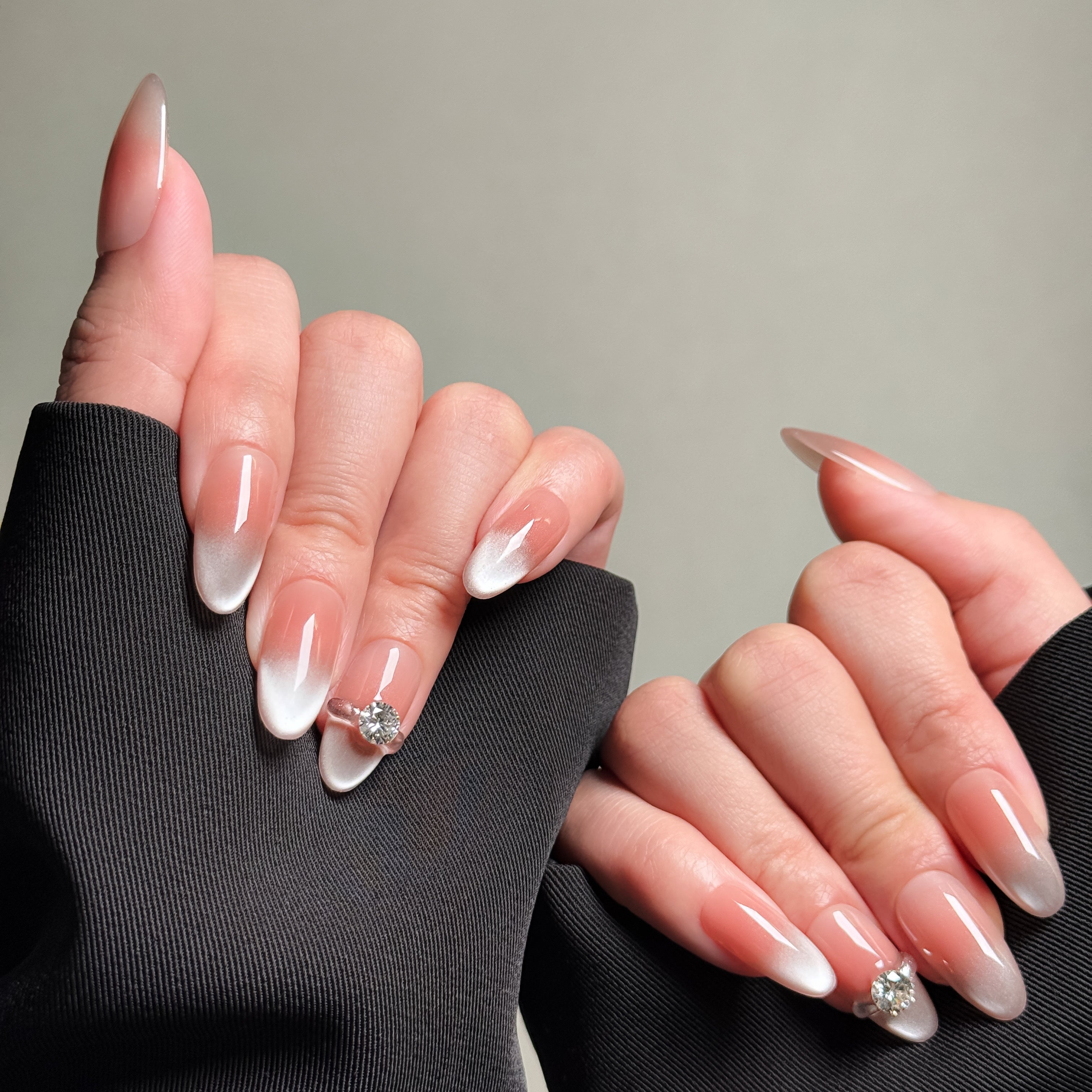 Hands displaying MIBLAB's Rhinestone nails in Stiletto nails shape with French tip nails design. Features nail accessories with subtle pink gradient. Ideal for wedding nails or party nails, showcasing luxury press on nails. Offers handmade press on nails with professional nail art detail and nail care tips.