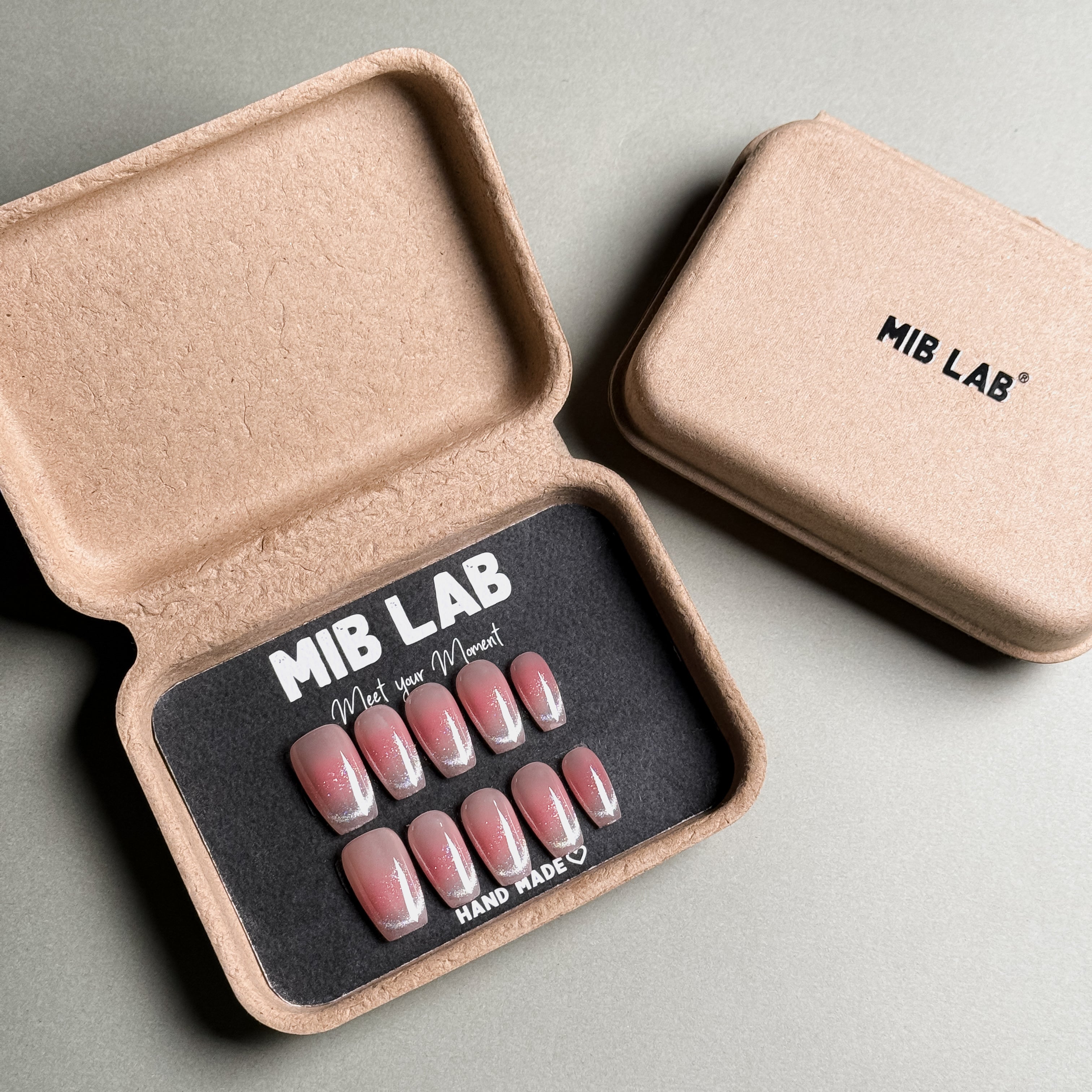 MIBLAB's French tip nails set with pink glitter accents, presented in eco-friendly packaging. Features "MIB LAB" branding and "HAND MADE ♡" detail. Perfect for everyday nails or party nails, offering a luxury press on nails experience. Includes reusable fake nails for a quick nail art solution.