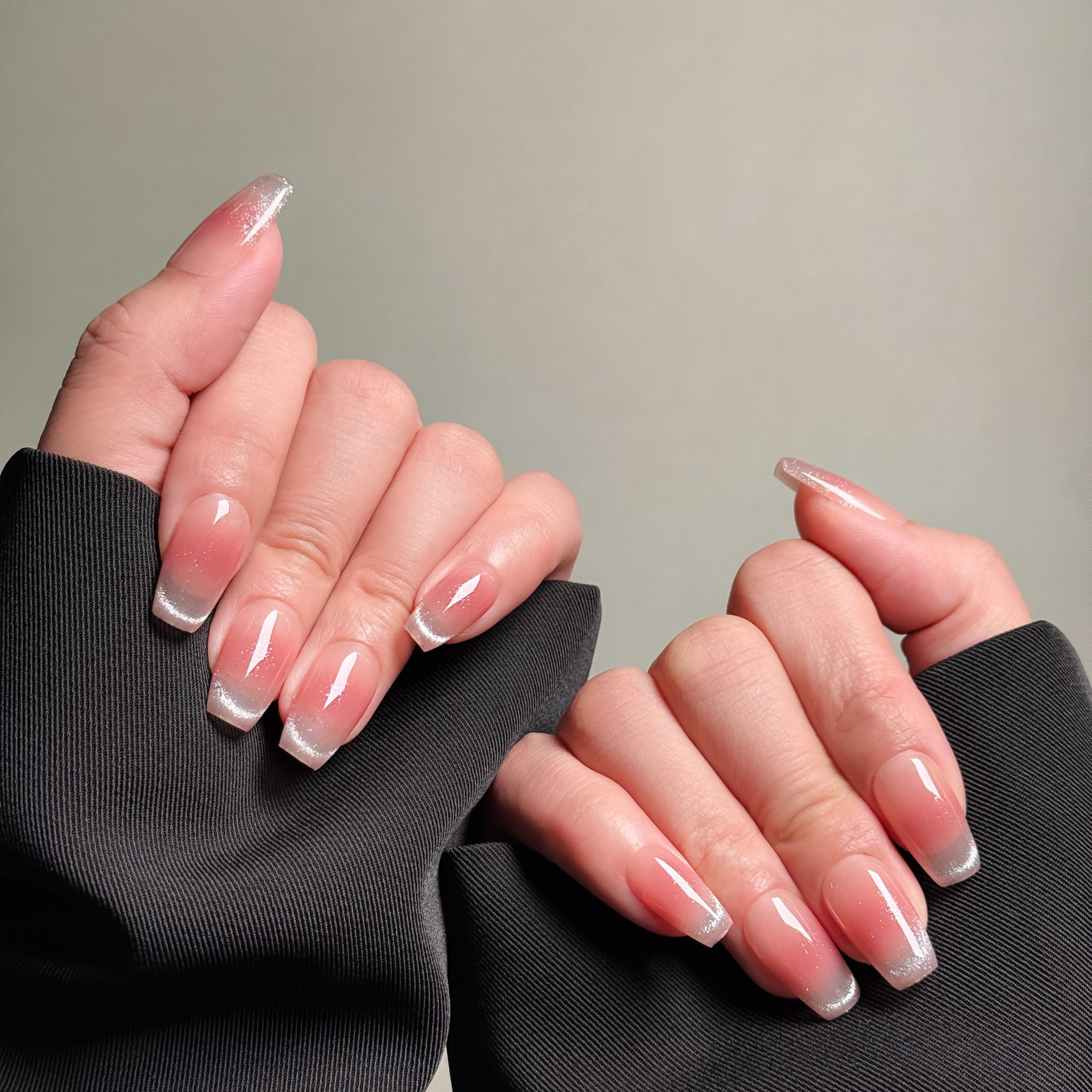 Hands showing MIBLAB's French tip nails with silver glitter, styled in long nails design. Features a subtle pink base, ideal for wedding nails or party nails. Offers a luxury press on nails experience with professional nail art feel. These are fake nails for easy, elegant styling.