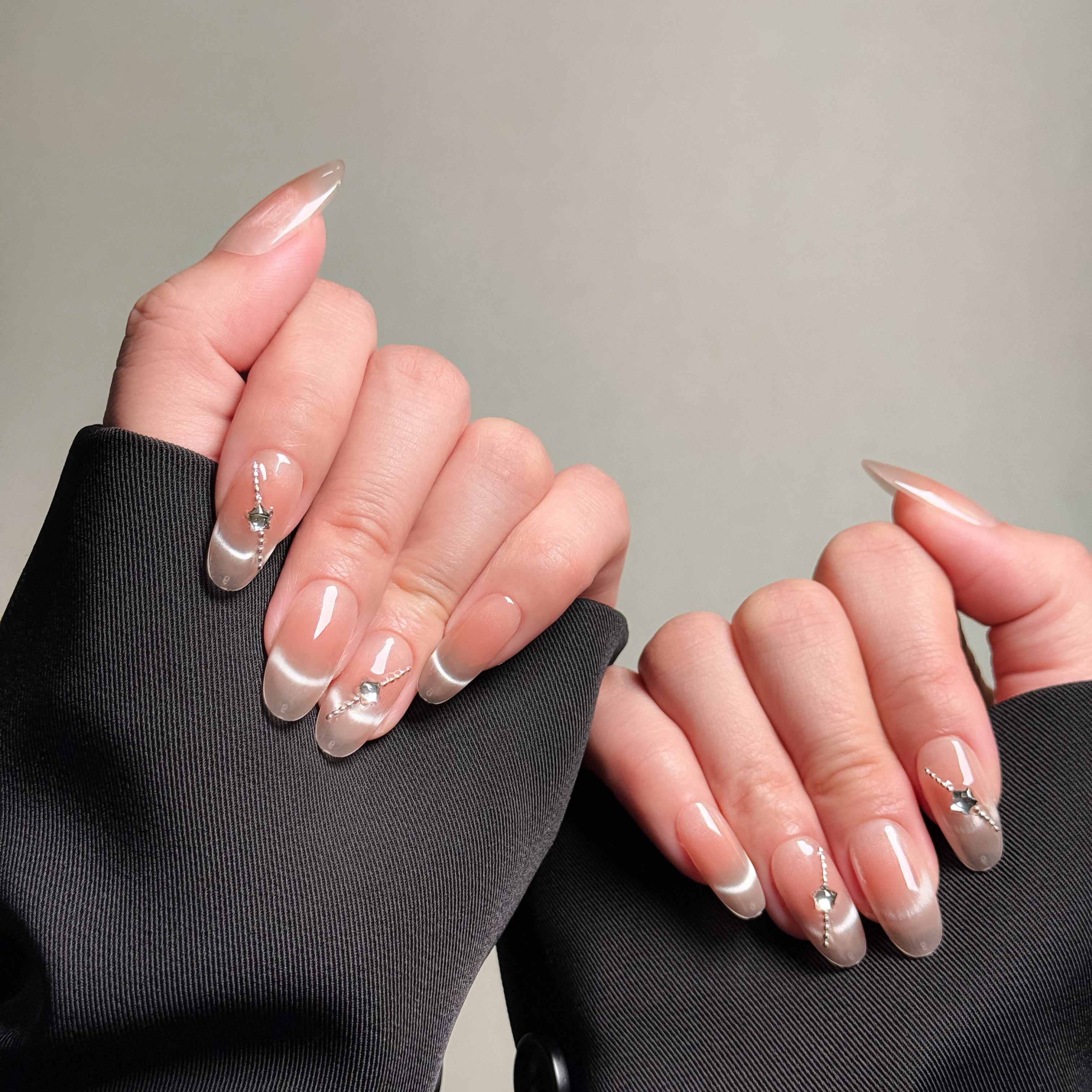 Elegant Almond nails featuring a nude base with delicate silver accents. These Natural looking nails offer a clean and sophisticated look, perfect for Everyday nails and professional settings. The subtle embellishments and glossy finish make them ideal for both casual and formal occasions. Ideal for those seeking Luxury press on nails that are both stylish and versatile.