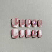 A set of "Carats" press - on nails in a rosy hue, adorned with glitter and featuring some nails with gem - like embellishments, perfect for adding a touch of luxury to party nail art.