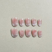 A set of "Moonlight" press - on nails with a soft pink gradient and delicate glitter accents, creating a natural yet sparkly look, perfect for daily nail adornment.