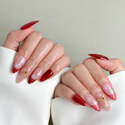 Model wearing MIBLAB Last Christmas red and nude pink glitter press-on nails, handcrafted reusable design available in Geneva.