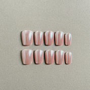 A set of Blush - named glittery custom press - on nails with a soft pink hue and shimmering glitter stripes, ideal for party and wedding nail art styles.