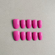 Two rows of MIBLAB's glue-on nails in a vibrant pink shade, featuring a high-gloss finish, arranged against a neutral gray background to highlight the clean design and bold color, with a gradient of sizes from large to small for a perfect fit, showcasing short nails design. These fake nails offer a quick and easy nail art solution for everyday nails or party nails, emphasizing the natural looking nails effect and reusable fake nails quality.