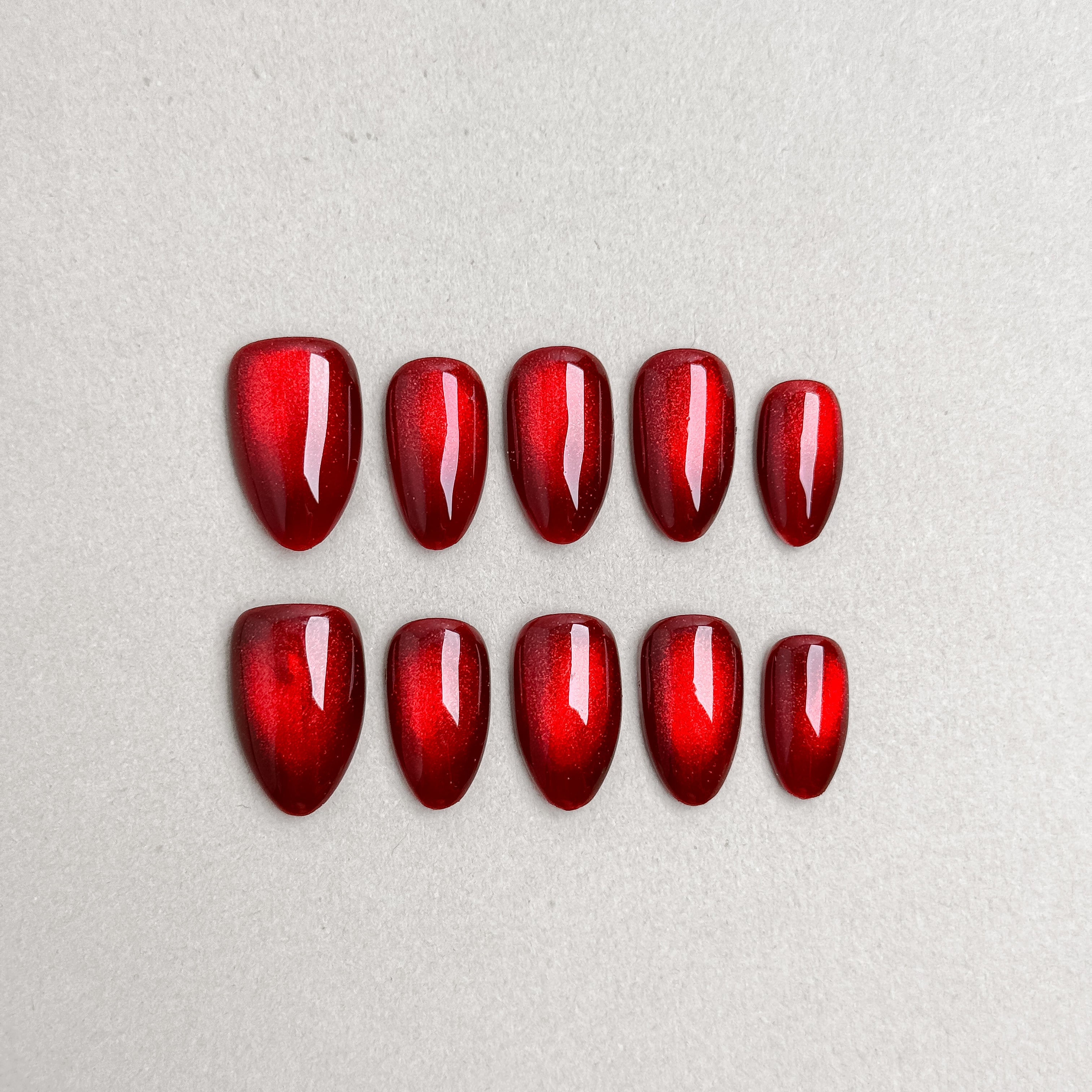 Set of reusable press-on nails in metallic cherry red with glossy finish, MIBLAB Merry Me collection Geneva.