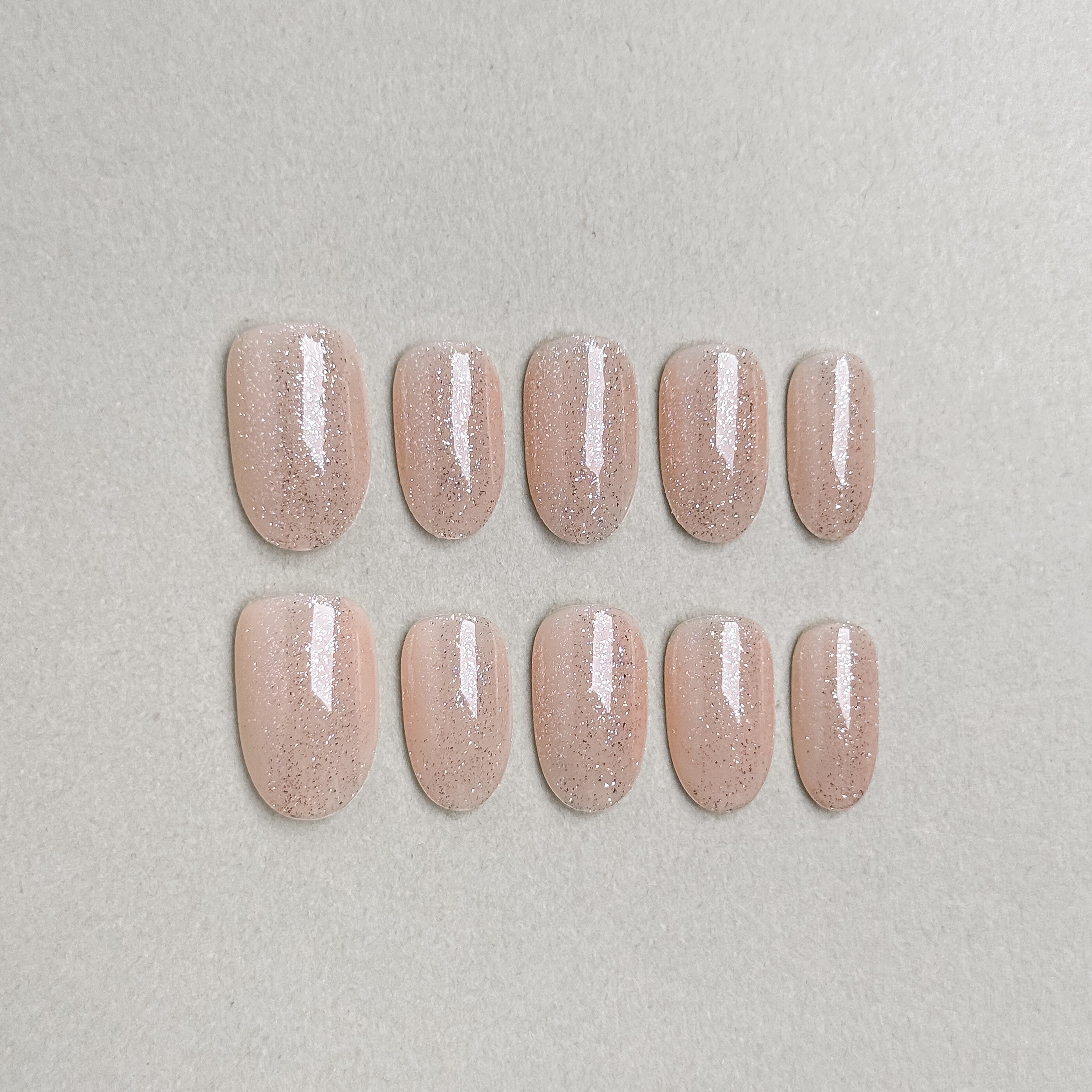 Set of reusable press-on nails in soft nude beige with subtle pearlescent finish, MIBLAB You and Me collection Geneva.