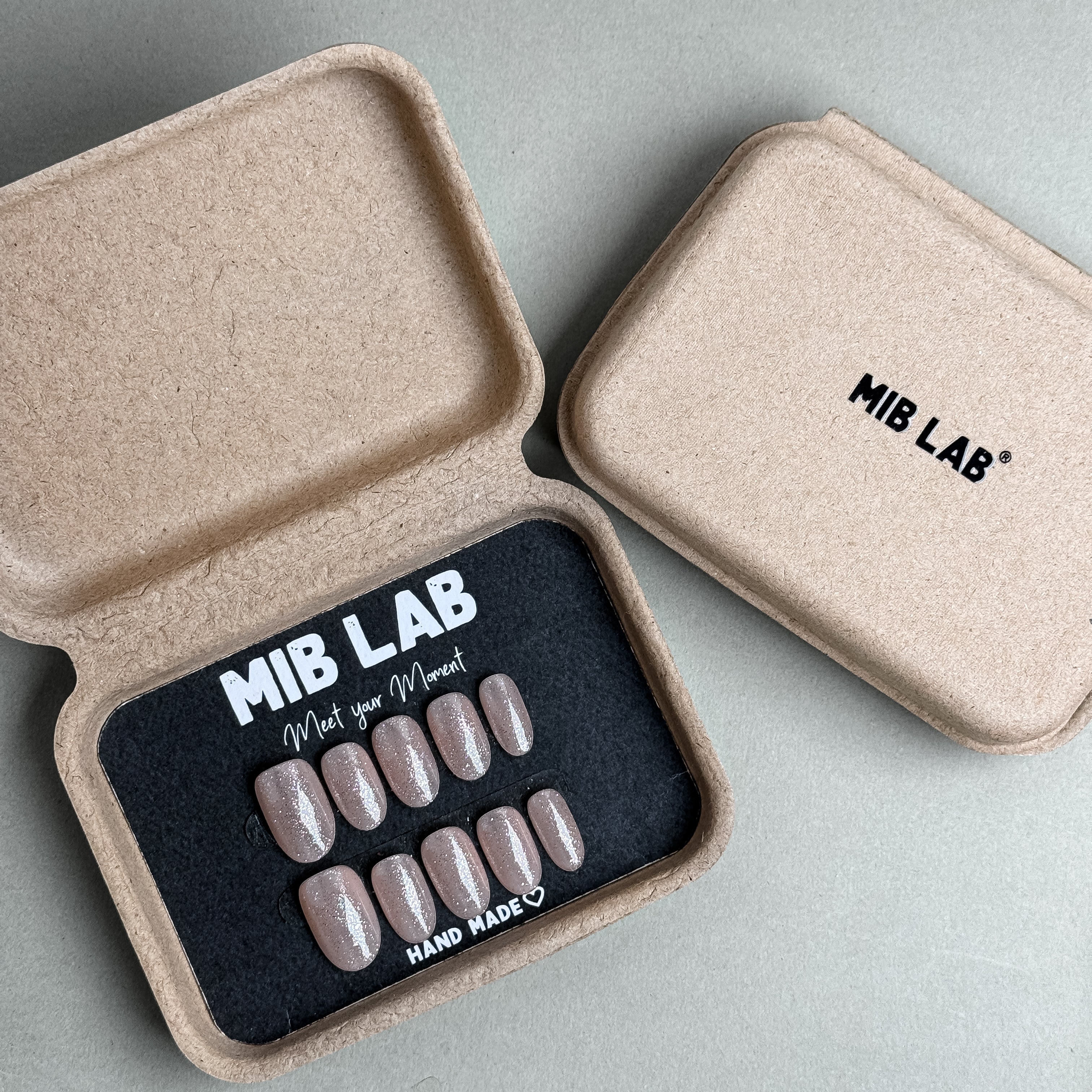 MIBLAB You and Me press-on nail set in light nude beige tone, packaged for boutique display in Geneva.