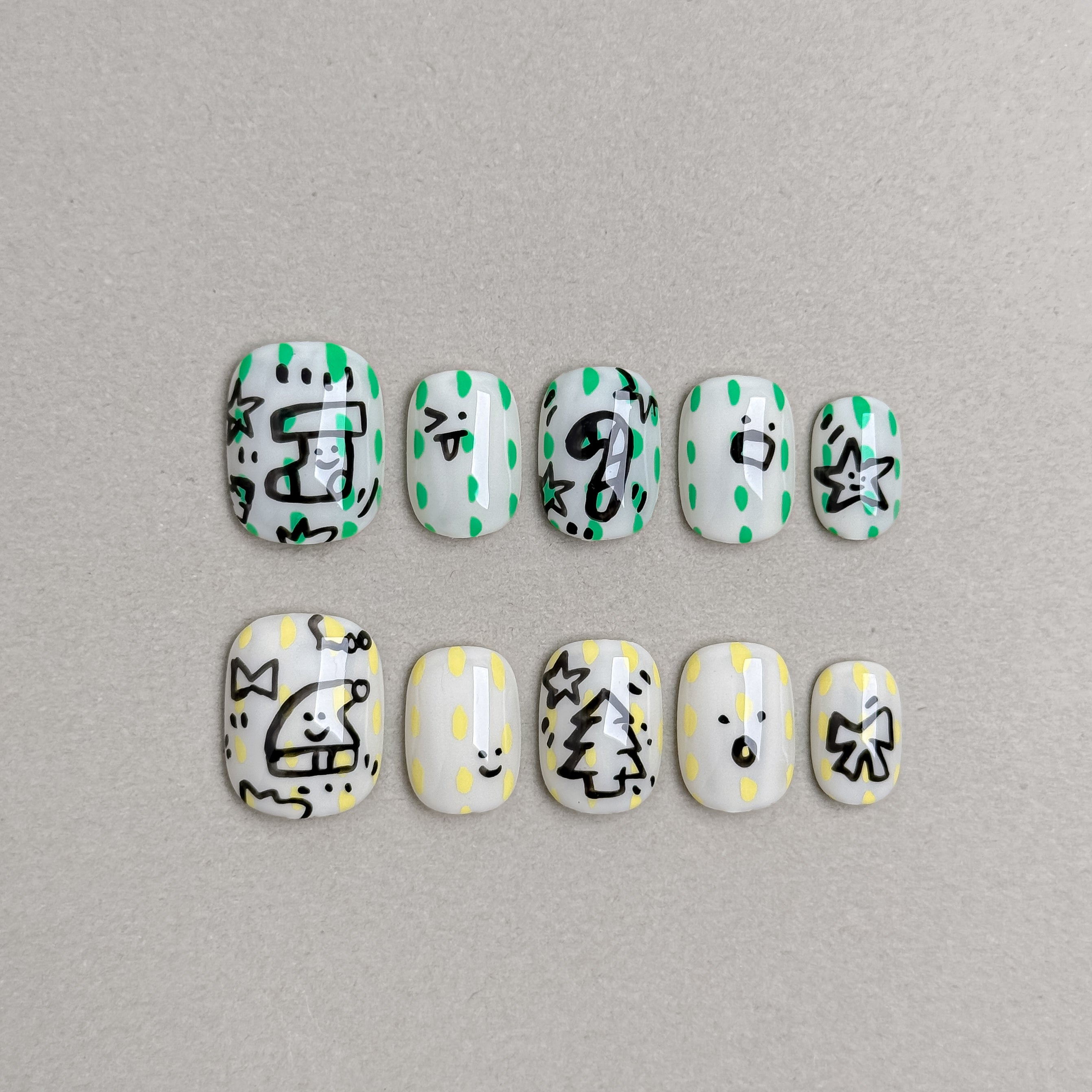 Set of reusable press-on nails in white and mint green with playful Christmas cookie designs, MIBLAB Jolly Cookie collection Geneva.