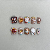 Heir : faux ongles réutilisables multicolores style bijou, motifs floraux et perles, accents dorés, press on nails premium.